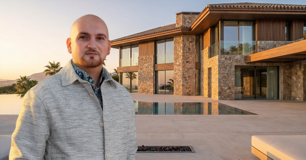 Sasan Raftari, real estate agent in Marbella, standing in front of a modern luxury villa with infinity pool during golden hour.